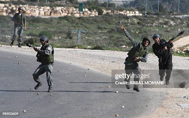 Israeli soldiers fire tear gas towards Palestinian protesters during clashes in the village of Nabi Saleh Halmish near a Jewish settlement west of...