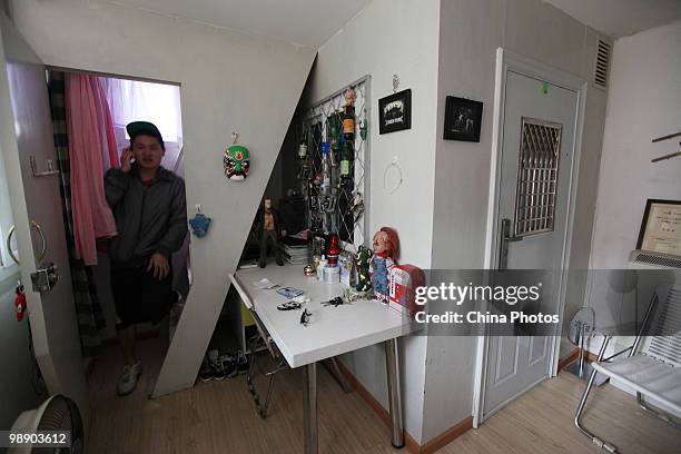 Tenant stands out of a 'deluxe version' of 'Capsule Apartments' newly built by Chinese senior citizen Huang Rixin, a 78-year-old retired engineer, is...