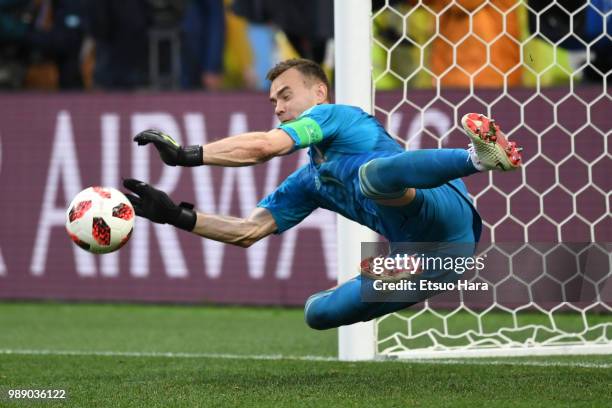 Igor Akinfeev of Russia saves the third penalty from Koke of Spain in the penalty shoot out during the 2018 FIFA World Cup Russia Round of 16 match...