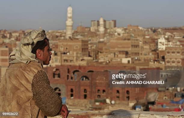 Yemeni man looks towards Sanaa's Old City on January 15, 2010. An air strike on an Al-Qaeda in the Arabian Peninsula position in north Yemen killed...