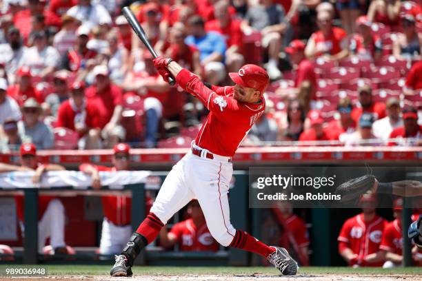 Joey Votto of the Cincinnati Reds hits a double to right field to drive in a run in the first inning against the Milwaukee Brewers at Great American...