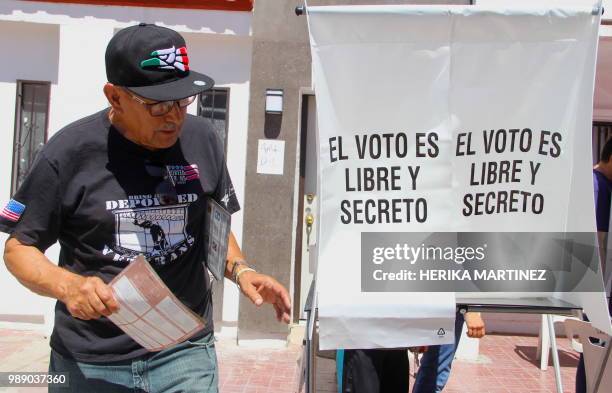 Francisco Lopez a Mexican veteran deported from the United States after fighting in the Vietnam war, prepares to cast his vote during the general...