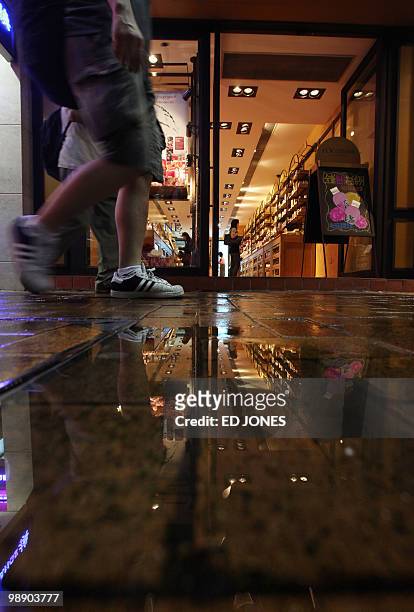 Pedestrians pass a branch of French cosmetics company L'Occitane, in the Causeway Bay district of Hong Kong on May 7, 2010. Shares in L'Occitane...