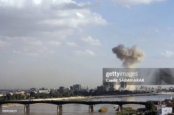 Smoke rises hundreds of metres into the sky following an explosion in the area near Baghdad's Palestine Hotel on January 25, 2010. Three massive...