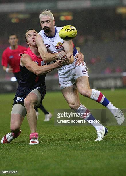 Jason Akermanis of the Bulldogs handballs under pressure during the round seven AFL match between the Melbourne Demons and the Western Bulldogs at...