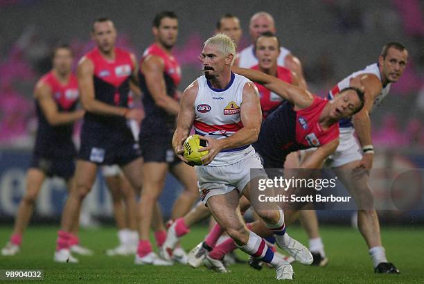 Jason Akermanis of the Bulldogs runs with the ball during the round seven AFL match between the Melbourne Demons and the Western Bulldogs at...