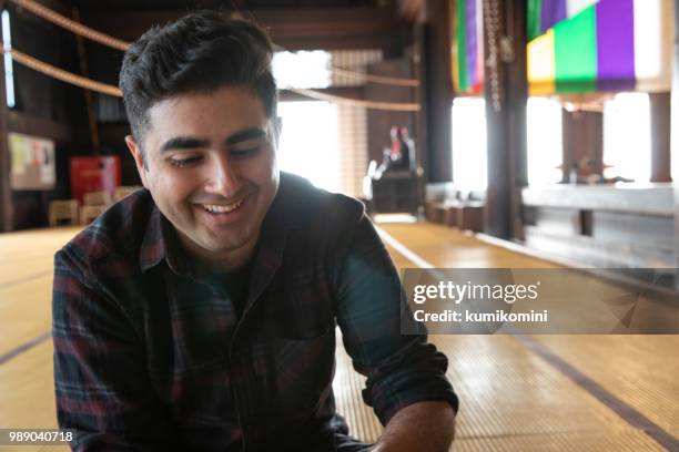 asian man sitting at temple - kumikomini stock pictures, royalty-free photos & images