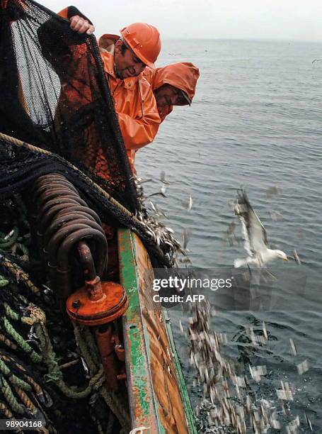 Fishermen clear the net off Concepcion, some 519 km south of Santiago, August 11, 2009. The authorities grant a fishing quota per season to each...