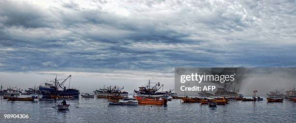 Chilean fishermen prepare their boats to go sailing, in "Caleta Tumbes" cove, Concepcion,some 519 km south of Santiago, August 11, 2009. The...