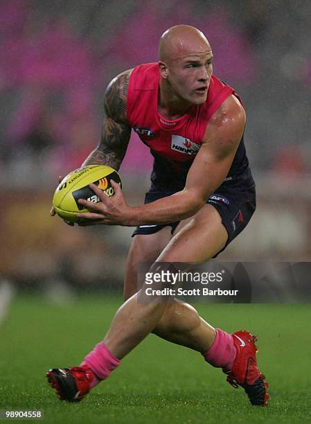 Nathan Jones of the Demons runs with the ball during the round seven AFL match between the Melbourne Demons and the Western Bulldogs at Melbourne...