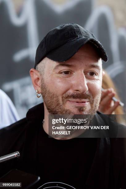 Fashion designer for Vetements, Demna Gvasalia talks to people at the end of his men and women's Spring/Summer 2019 collection fashion show, in...