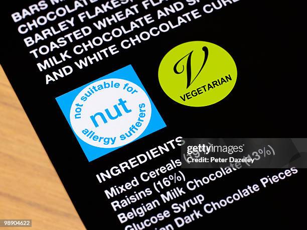 nut allergy warning on packaging - warning symbol stock pictures, royalty-free photos & images