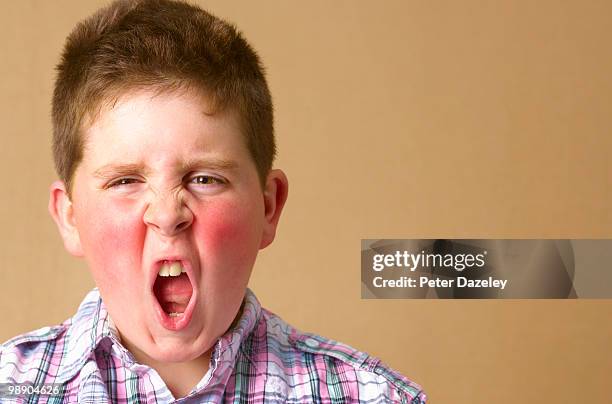 angry 12 year old boy shouting - rosy cheeks fotografías e imágenes de stock