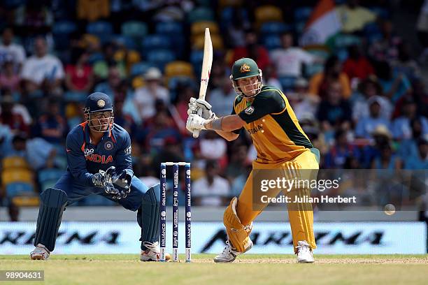 Dhoni of India looks on as Shane Watson hits out during The ICC World Twenty20 Super Eight Match between Australia and India played at The Kensington...