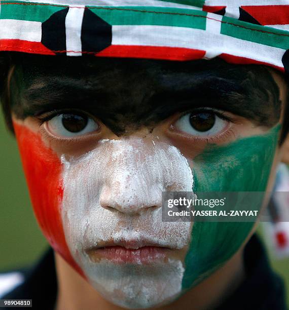 Kuwaiti boy with his face painted in the colours of his national flag attends celebrations marking the Gulf emirate's national and liberation days in...