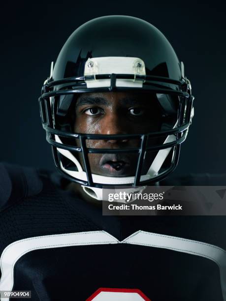 portrait of sweating football player - football helmet stock pictures, royalty-free photos & images