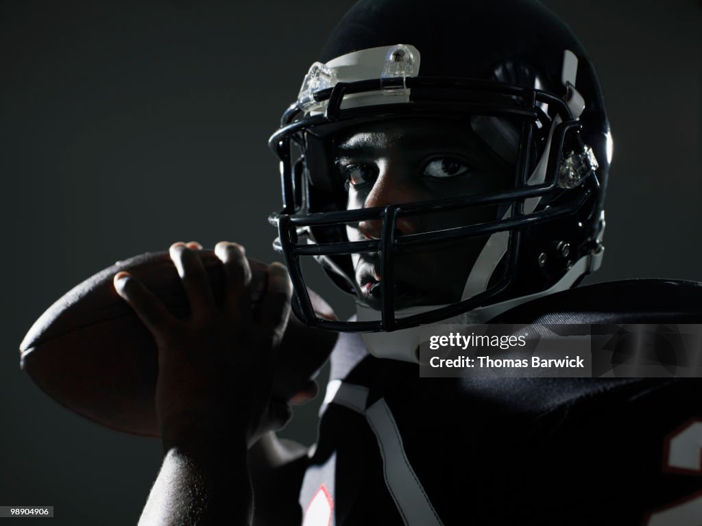 Football quarterback preparing to throw pass