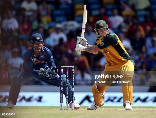 Dhoni of India looks on as Shane Watson hits out during The ICC World Twenty20 Super Eight Match between Australia and India played at The Kensington...