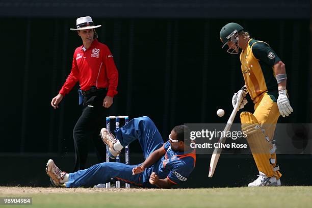 Yusuf Pathan of India struggles to stop the ball as Shane Watson of Australia looks on during the ICC World Twenty20 Super Eight match between...