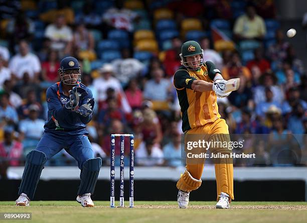 Dhoni of India looks on as Shane Watson hits out during The ICC World Twenty20 Super Eight Match between Australia and India played at The Kensington...