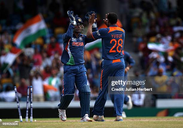 Dhoni and Yusuf Pathan of India celebrate the wicket of Shane Shane Watson during The ICC World Twenty20 Super Eight Match between Australia and...