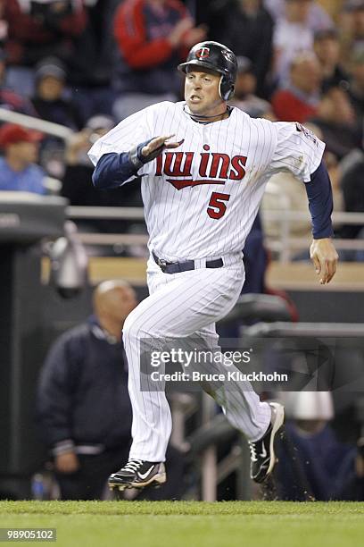 Michael Cuddyer of the Minnesota Twins runs home to score against the Detroit Tigers on May 3, 2010 at Target Field in Minneapolis, Minnesota. The...