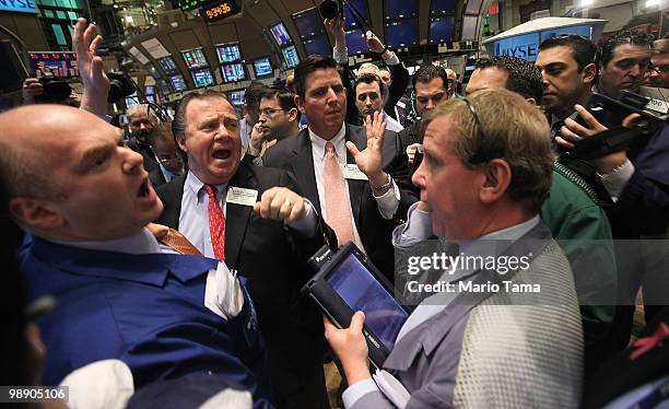 Traders work on the floor of the New York Stock Exchange after the opening bell May 7, 2010 in New York City. Stocks began the session mixed after a...