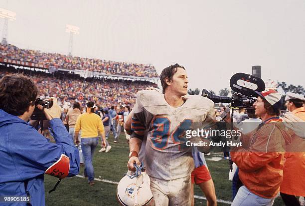 Playoffs: Miami Dolphins Bruce Hardy victorious, running off field after winning game vs New York Jets. Mud Bowl. Miami, FL 1/23/1983 CREDIT: Andy...