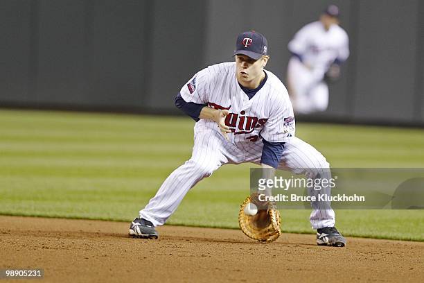 Justin Morneau of the Minnesota Twins fields a ball hit by the Detroit Tigers on May 3, 2010 at Target Field in Minneapolis, Minnesota. The Twins won...