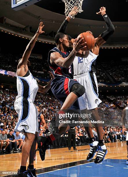 Joe Johnson of the Atlanta Hawks moves the ball against Dwight Howard of the Orlando Magic in Game Two of the Eastern Conference Semifinals during...