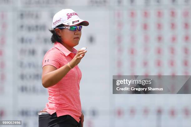 Nasa Hataoka of Japan acknowledges fans after a par on the 18th green during the final round of the 2018 KPMG PGA Championship at Kemper Lakes Golf...