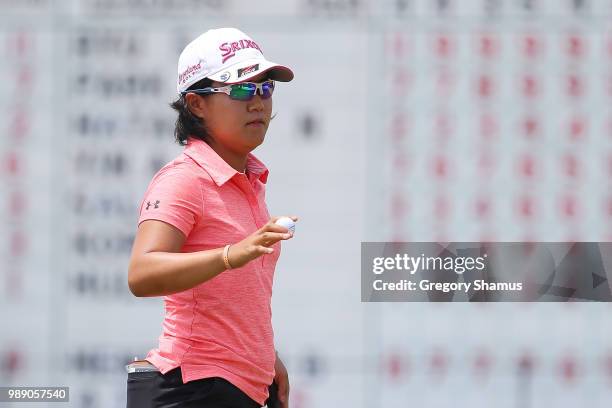 Nasa Hataoka of Japan acknowledges fans after a par on the 18th green during the final round of the 2018 KPMG PGA Championship at Kemper Lakes Golf...