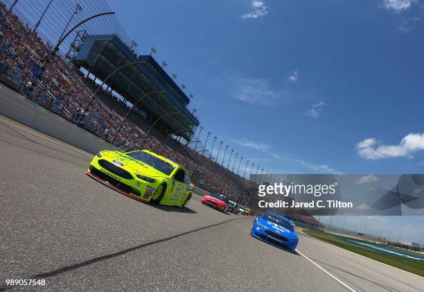 Paul Menard, driver of the Menards/Sylvania Ford, and Ryan Blaney, driver of the PPG Ford, lead the field prior to the start of the Monster Energy...