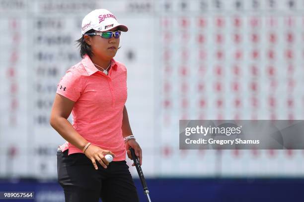 Nasa Hataoka of Japan acknowledges fans after a par on the 18th green during the final round of the 2018 KPMG PGA Championship at Kemper Lakes Golf...