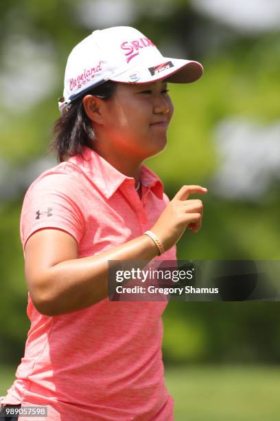Nasa Hataoka of Japan acknowledges fans after a par on the 18th green during the final round of the 2018 KPMG PGA Championship at Kemper Lakes Golf...