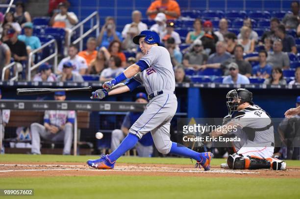 Todd Frazier of the New York Mets loses his bat as he swings at a pitch during the second inning against the Miami Marlins at Marlins Park on July 1,...