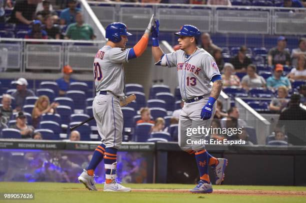 Asdrubal Cabrera of the New York Mets is congratulated by Michael Conforto after hitting a home run in the third inning against the Miami Marlins at...