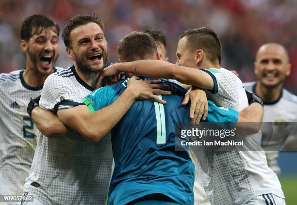 Vladimir Granat of Russia celebrates with goalkeeper Igor Akinfeev of Russia when they win the penalty shoot out during the 2018 FIFA World Cup...