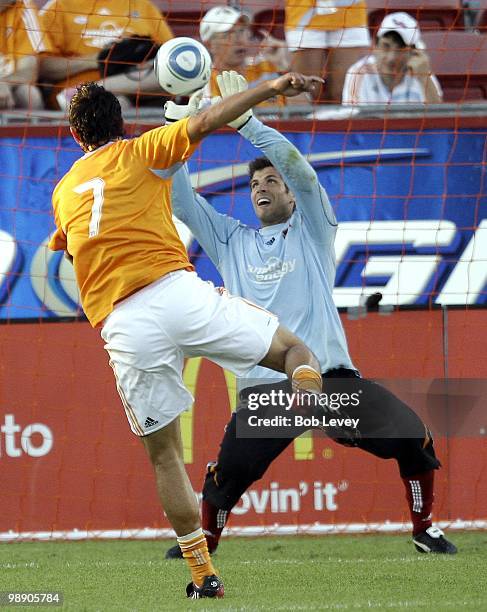 Goalkeeper Tally Hall of the Houston Dynamo blocks a shot from teammate Luis Landin during pre-game warm ups before playing against FC Dallas at...