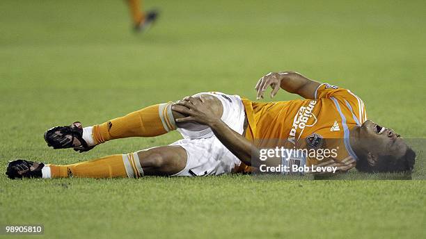 Forward Luis Landin of the Houston Dynamo lays on the field in pain after taking a hard hit against FC Dallas at Robertson Stadium on May 5, 2010 in...