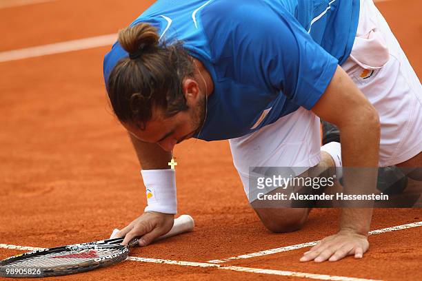 Marcos Baghdatis of Cyprius kisses the field after winning his match against Philipp Kohlschreiber of Germany on day 6 of the BMW Open at the Iphitos...