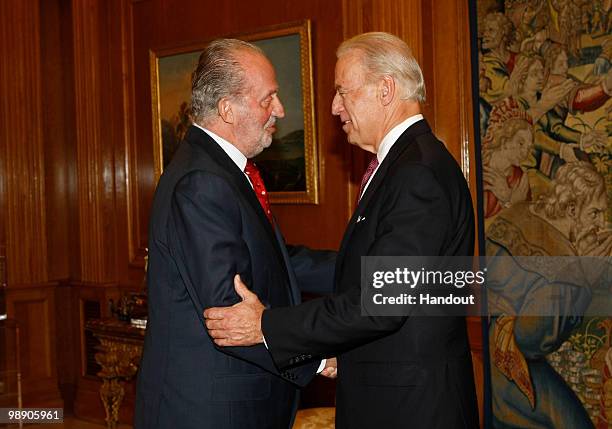 In this handout photo provided by the Spanish Royal House, King Juan Carlos of Spain greets US vice president Joe Biden, at Zarzuela Palace, May 07,...