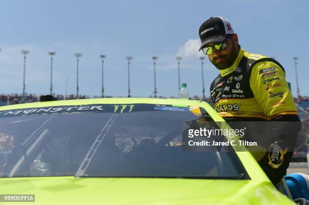 Paul Menard, driver of the Menards/Sylvania Ford, climbs into his car prior to the Monster Energy NASCAR Cup Series Overton's 400 at Chicagoland...