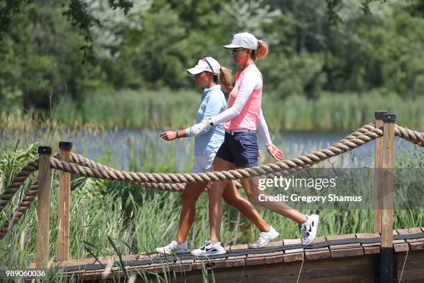 Danielle Kang and Michelle Wie walk from the 17th green to the 18th green during the final round of the 2018 KPMG PGA Championship at Kemper Lakes...