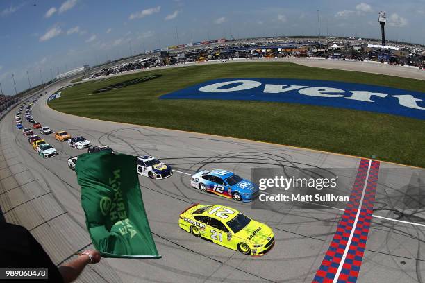 Paul Menard, driver of the Menards/Sylvania Ford, and Ryan Blaney, driver of the PPG Ford, lead the field to the green flag to start the Monster...