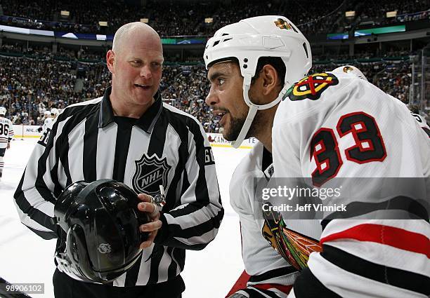 Dustin Byfuglien of the Chicago Blackhawks talks to linesman Scott Driscoll in Game Three of the Western Conference Semifinals against the Vancouver...