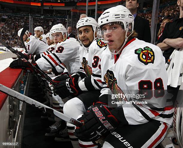 Patrick Kane, Dustin Byfuglien and Jonathan Toews of the Chicago Blackhawks look on from the bench in Game Three of the Western Conference Semifinals...