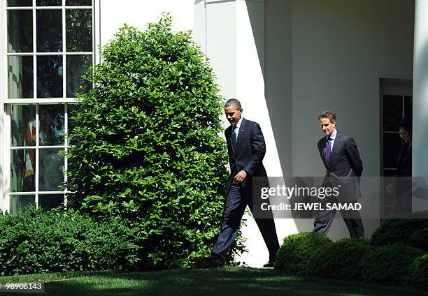 President Barack Obama is followed by by Secretary of Treasury Timothy Geithner and Secretary of Labor Hilda Solis as he arrives to speak on monthly...
