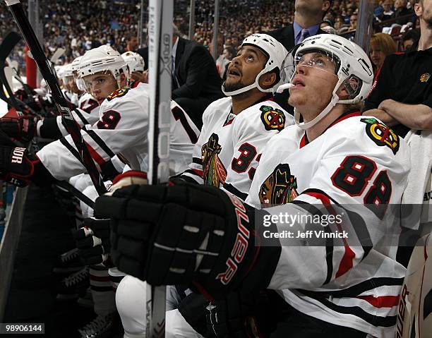 Patrick Kane, Dustin Byfuglien and Jonathan Toews of the Chicago Blackhawks look on from the bench in Game Three of the Western Conference Semifinals...