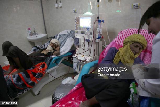 An African migrant patient, who will be repatriated to their countries, receives medical treatment at Tamanrasset Hospital of the refugee camp...